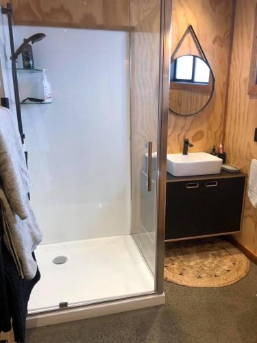 a bathroom with a shower and a sink at Tau Studio - Boutique Accommodation in Ohakune