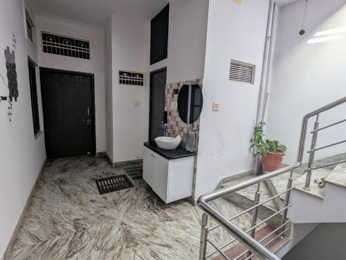 a bathroom with a sink and a mirror on the wall at Punia's Staycation in Udaipur