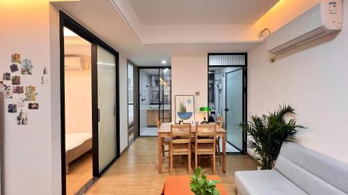 a dining room and living room with a table at House of Great White Apartment in Shenzhen