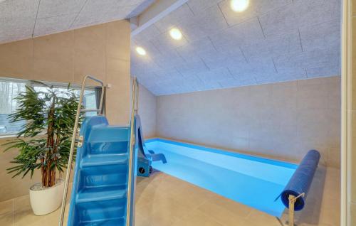 a swimming pool with a blue slide in a room at Stunning Home In Jesendorf With Sauna in Jesendorf