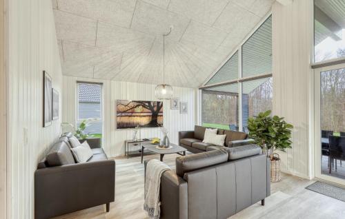 a living room with two couches and a table at Stunning Home In Jesendorf With Sauna in Jesendorf