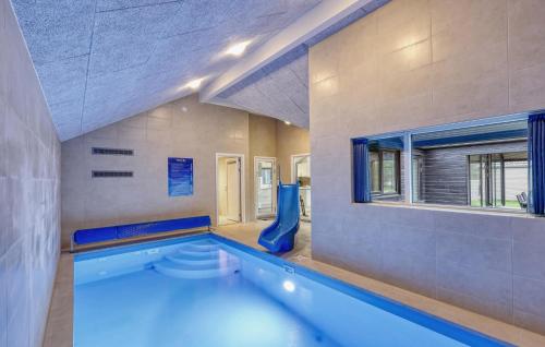 a large swimming pool in a room with a swimming pool at Lovely Home In Jesendorf With Sauna in Jesendorf