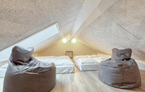 a attic bedroom with two beds and a sloped ceiling at Lovely Home In Jesendorf With Sauna in Jesendorf