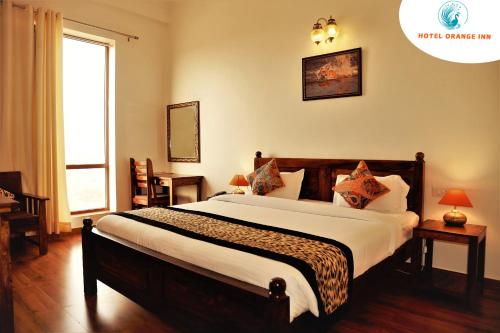 a bedroom with a large bed in a room at Hotel Orange inn Kodaikanal in Kodaikānāl