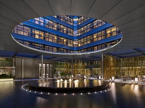 a lobby of a building with a large building at Hilton Shanghai Hongqiao International Airport in Shanghai