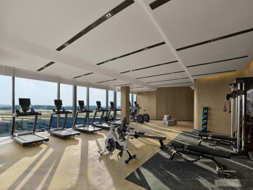 a gym with treadmills and elliptical machines at Hilton Shanghai Hongqiao International Airport in Shanghai