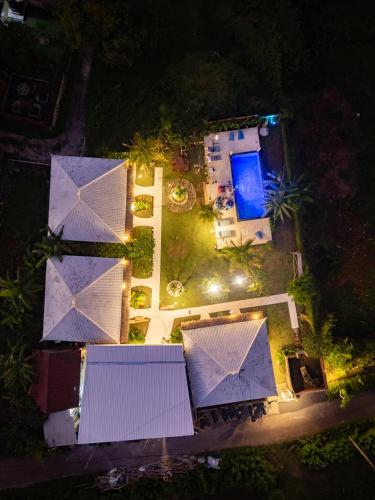 an overhead view of a resort at night with purple umbrellas at Sukacita Hill in Uluwatu