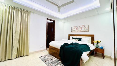 a bedroom with a bed and a window at Olive Service Apartments - Green Park in New Delhi