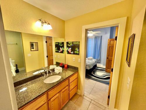 a bathroom with a sink and a large mirror at Somehow, Someday, Somewhere, Seaside in St. George Island