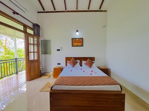 a bedroom with a large bed in a room at Tropical Oasis in Teldeniya
