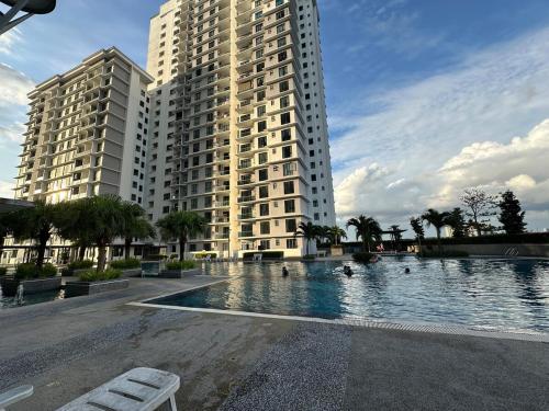 a large building with a swimming pool in front of a building at The Platino 6 to 8pax 2 carpark with Nextflix 5min to Paradigm in Johor Bahru