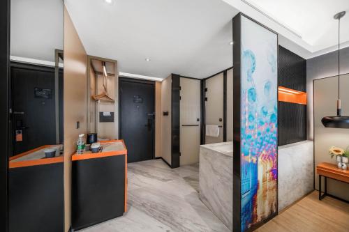 a room with a bathroom with a shower and a sink at Atour S Hotel Chengdu Taikoo Li in Chengdu