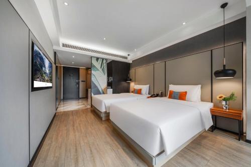 a hotel room with two beds and a flat screen tv at Atour S Hotel Chengdu Taikoo Li in Chengdu