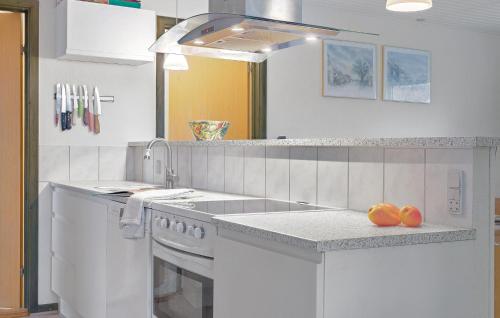 a white kitchen with a sink and a dishwasher at Lovely Home In Samsø With Wifi in Nordby
