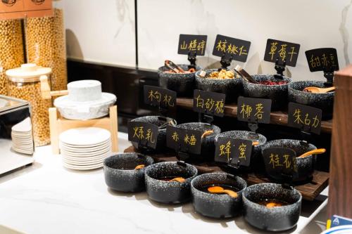 a display of sushi bowls with writing on them at Atour S Hotel Chengdu Taikoo Li in Chengdu