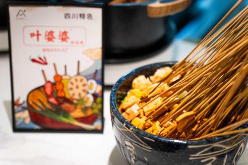a bowl of food with a pair of chopsticks in it at Atour S Hotel Chengdu Taikoo Li in Chengdu