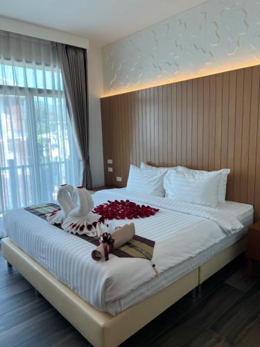 Postel nebo postele na pokoji v ubytování Baannalin Hometel บ้านนลิน โฮมเทล