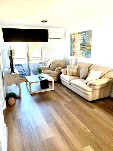 a living room with a couch and a table at Right in Fremantle in Fremantle