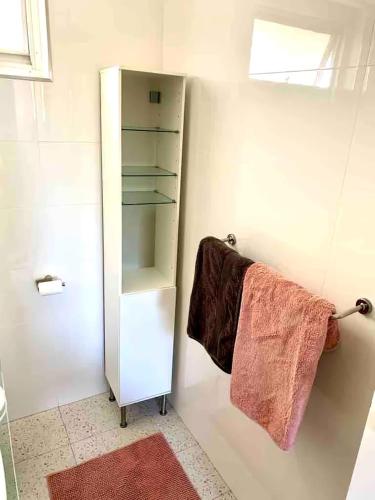 a bathroom with a towel hanging on a wall at Right in Fremantle in Fremantle
