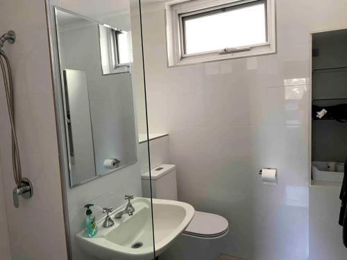 a bathroom with a sink and a toilet and a mirror at Right in Fremantle in Fremantle