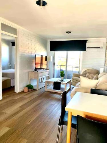 a living room with a couch and a table at Right in Fremantle in Fremantle