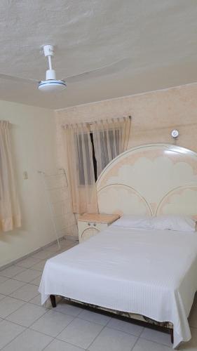 a bedroom with a large white bed in a room at San Bernardino 2 in Valladolid
