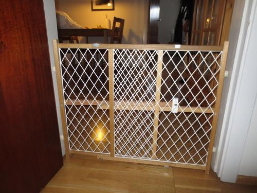 a gate in a room with a wooden door at Teigur Guesthouse in Akranes