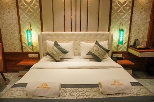 a bedroom with a bed with two pillows on it at Hotel Spencer-Navi Mumbai in Navi Mumbai