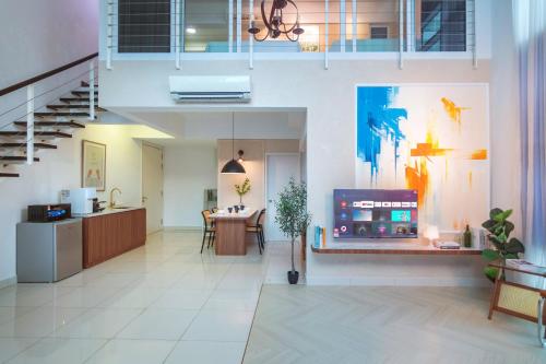 a living room with a tv and a dining room at Maritime Suites by Stellar ALV in Jelutong