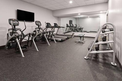 a gym with a row of exercise bikes and treadmills at Hawthorn Extended Stay by Wyndham Ellsworth Bar Harbor in Ellsworth