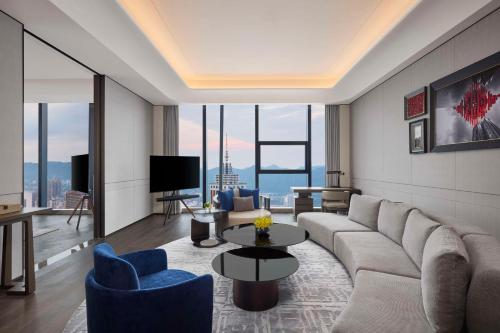 a living room with a couch and a table at Conrad Chongqing - Indulge in the magical 8D city landscape in Chongqing