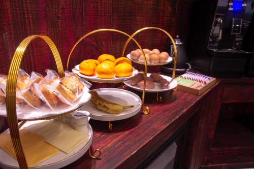 a buffet with plates of food on a table at Daegu February Hotel DongdaeguStation in Daegu