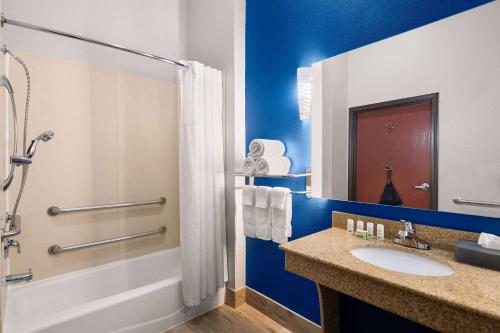 a bathroom with a sink and a shower at La Quinta by Wyndham Denton - University Drive in Denton