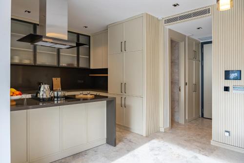 a kitchen with white cabinets and a black counter top at Villa with Private Swimming Pool in Bodrum in Bodrum City