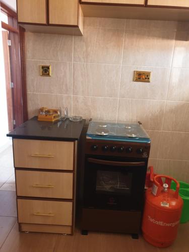 a kitchen with a stove and a counter top at The Golden Enclave Nakuru Fully Furnished Apartments in Nakuru