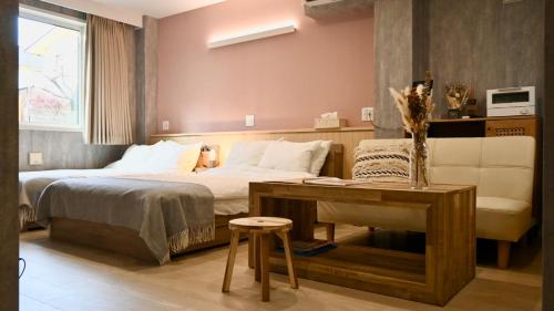 a hotel room with a bed and a table and a desk at Class Kyodo in Tokyo