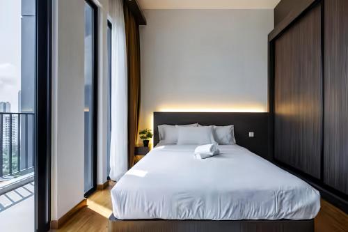 a bedroom with a white bed and a large window at Beacon Executive Suite in George Town