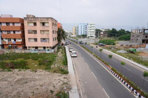 a city street with cars parked on the side of the road at TIRUMALA PREMIUM HOME STAY in Tirupati