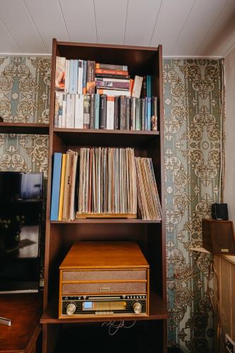 a book shelf filled with records and a wooden box at Altes Häusle am Waschbach-Weinberg in Edenkoben