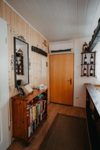 a room with a wooden door and a book shelf with books at Altes Häusle am Waschbach-Weinstock in Edenkoben