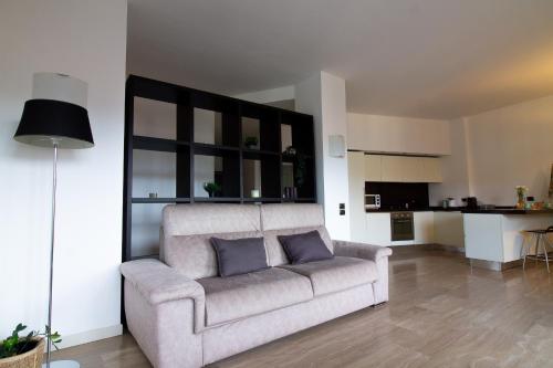a living room with a couch with two pillows at Sium's Suite Apartment 2 in Como