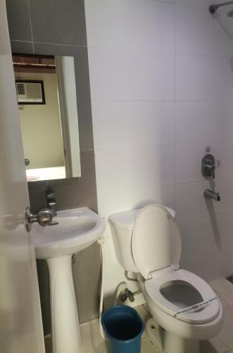 a bathroom with a toilet and a sink at Hotel Sogo Dasmariñas Cavite in Dasmariñas