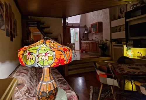 a stained glass lamp sitting on a couch in a living room at Casa Carina in Verona