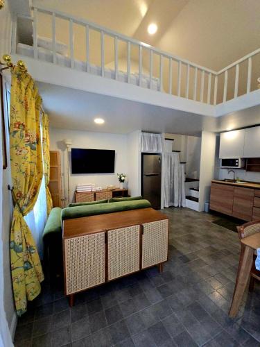 a living room with a loft bed and a kitchen at La Campagne Villa Chiangmai in Chiang Mai