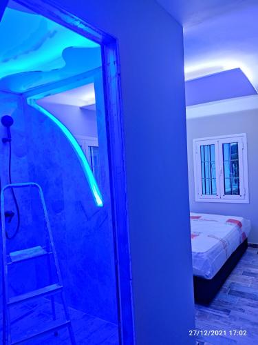 a mirror in a room with a bed and a ladder at Oinos Luxury apartment in Faliraki