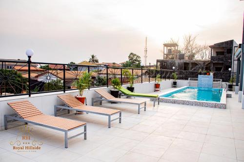 a balcony with a swimming pool on a building at Royal Hillside Apartments and Hotels in Yaoundé