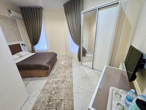 a hotel room with a bed and a mirror at Mark Plaza Hotel in Mykolaiv