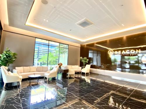 a lobby with couches and tables in a building at Beacon Executive Suite in George Town