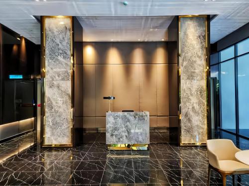 a lobby with a bench in the middle of a building at Beacon Executive Suite in George Town