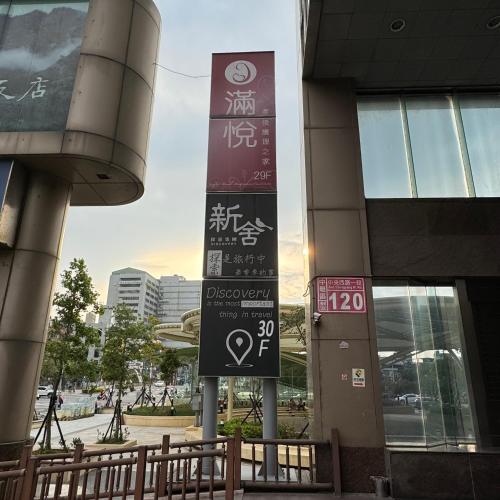 a sign in front of a building with writing on it at XinsheHotel - Chungli in Zhongli